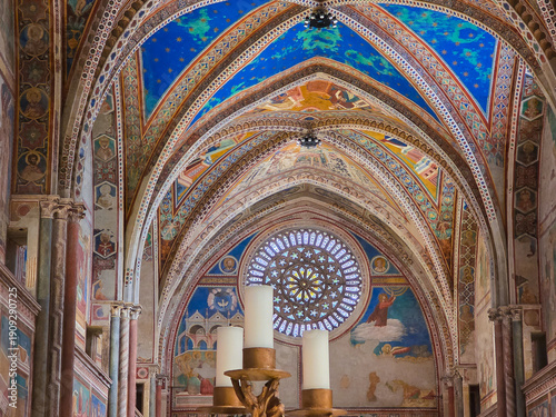 Interior of the Upper Basilica of San Francesco in Assisi featuring medieval frescoes by Giotto, a gothic rose window and starry blue vaulted ceilings, UNESCO site, Umbria, Italy