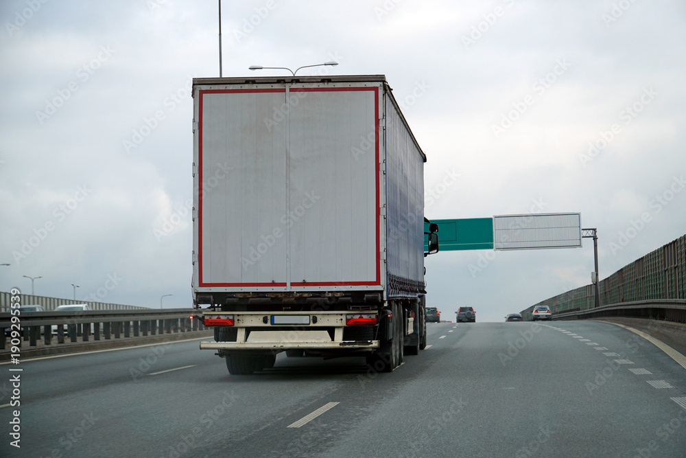 Naklejka premium Heavy Truck Transports Cargo on a Highway