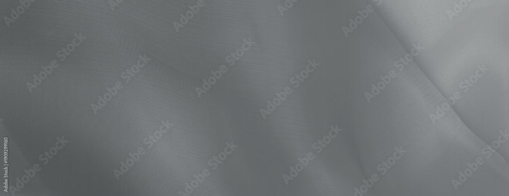 Fototapeta premium Gray background with a smooth, flowing texture. The background features soft, gray waves creating a serene, elegant look. Minimal abstract wavy gradient vector background