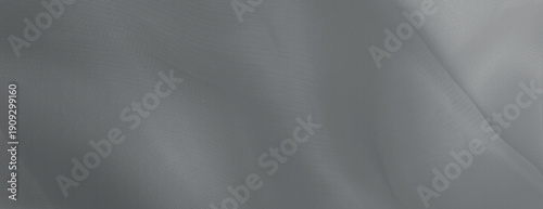 Gray background with a smooth, flowing texture. The background features soft, gray waves creating a serene, elegant look. Minimal abstract wavy gradient vector background