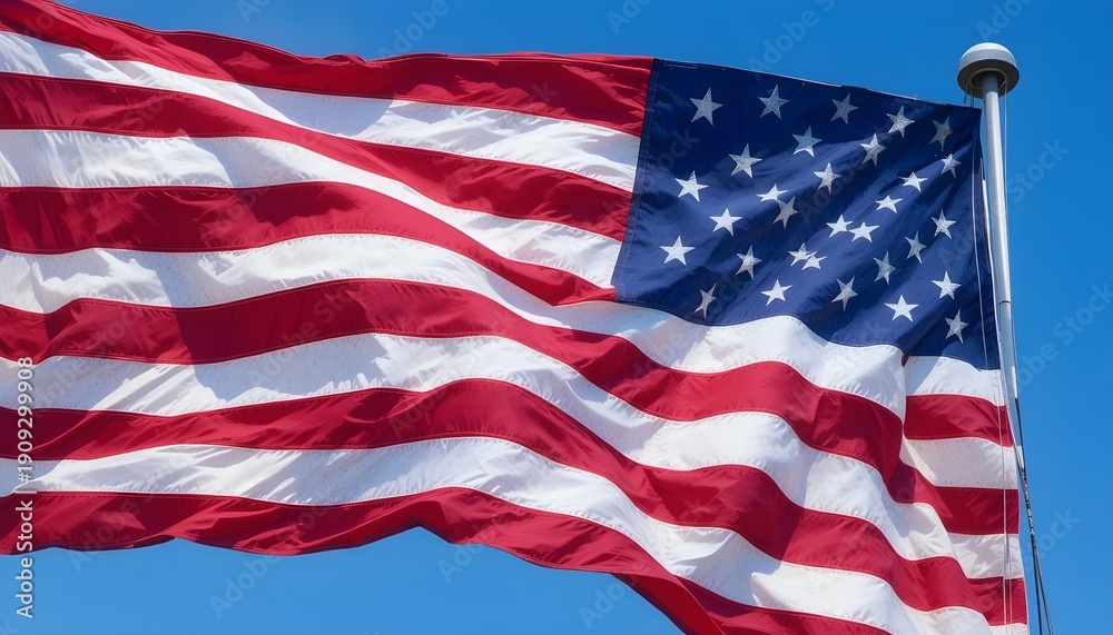 Fototapeta premium American flag waving proudly in the wind on a sunny day