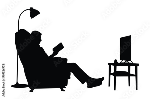 Silhouette of a man in an armchair reading a book with a TV nearby, evoking a sense of relaxation and calmness.