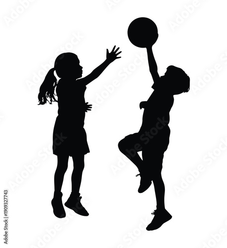 Silhouette of two children playing basketball and high-fiving in a dynamic, joyful moment. Two girls playing basketball together in joyful moment. 
