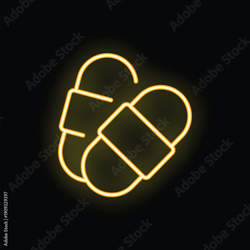 Neon sign of slippers glowing in yellow on black background