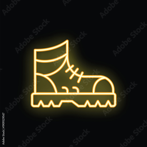 Neon sign depicting a hiking boot with thick outsole glowing yellow against a dark background, perfect for themes of outdoor activities