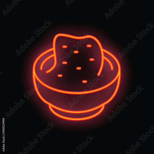 Neon sign depicting a bowl full of salsa with a tortilla chip dipping in, glowing on a black background