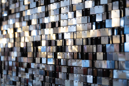 Glamour mirrored background made of small broken mirror pieces arranged in a textured mosaic pattern. 