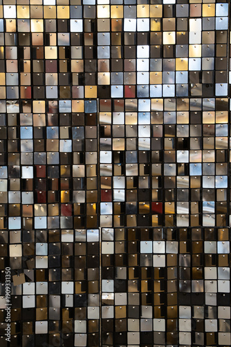 Glamour mirrored background made of small broken mirror pieces arranged in a textured mosaic pattern. 