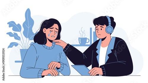 Compassionate man with headphones comforting a crying woman sitting at a table in a supportive and empathetic office environment.