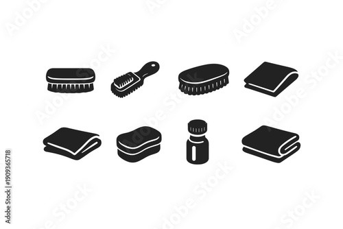 Set of eight black and white cleaning tools icons including brushes and towels