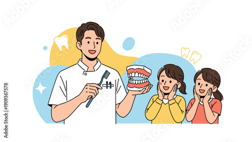 Friendly male dentist showing a large dental model of teeth to two happy young girls in a bright clinic setting.