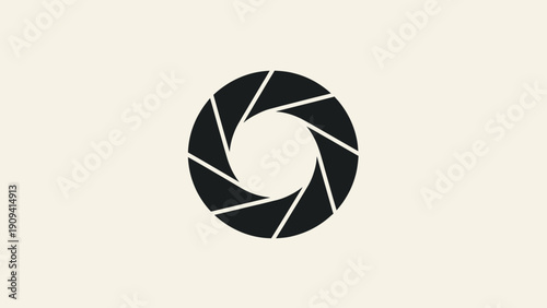 A black, circular aperture icon with triangular blades set against a beige background
