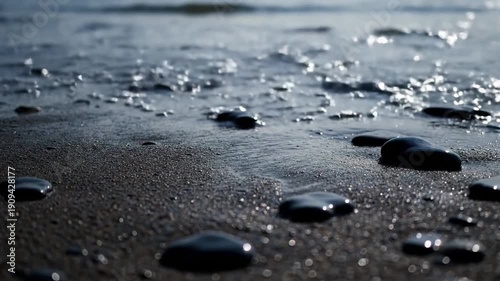 Intertidal Zone Details Focus on the transition point where gentle waves meet sand and small pebbles.