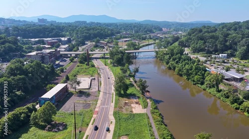 Aerial view of Asheville city in North Carolina with high buildings and Appalachian mountain hills