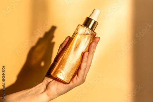 Hand, face or body lotion. A woman's hand holding a mock-up of a glass jar of lotion on a light background. The concept of cosmetics, skin care, nutrition and hydration.