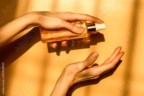 Hand, face or body lotion. A woman's hand holding a mock-up of a glass jar of lotion on a light background. The concept of cosmetics, skin care, nutrition and hydration.