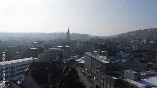 Wallpaper Mural Aerial perspective hovers above urban landscape of Bielefeld, Germany, capturing snowy rooftops on a bright winter day Torontodigital.ca