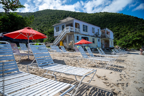 Old abandoned Beach Hotel in the Caribbean Tortola with sunbeams in foreground 