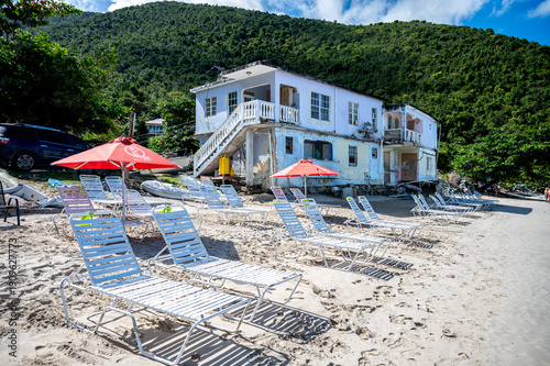 Old abandoned Beach Hotel in the Caribbean Tortola with sunbeams in foreground 