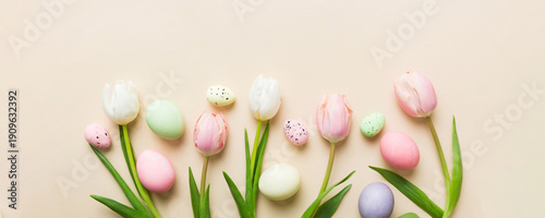 Wallpaper Mural Happy Easter composition. Easter eggs on colored table with yellow Tulips. Natural dyed colorful eggs background top view with copy space Torontodigital.ca