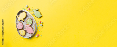 Wallpaper Mural Colorful easter cookies in basket with Multi colors Easter eggs on colored background . Pastel color Easter eggs. holiday concept with copy space Torontodigital.ca