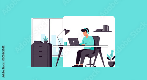 Young man working on laptop at desk with headphones.