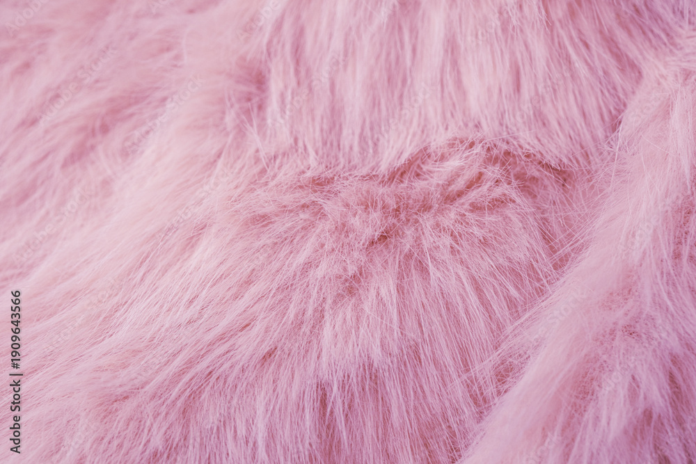 Fototapeta premium A luxurious soft pastel pink faux fur fabric material background texture close up surface detail