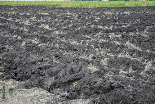 Фотография Aerial view of freshly plowed field with dark fertile soil