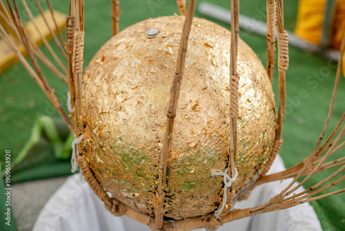 Tableau sur toile Luk Nimit, Golden consecration ball used in Thai temple ceremony, symbolizing Bu