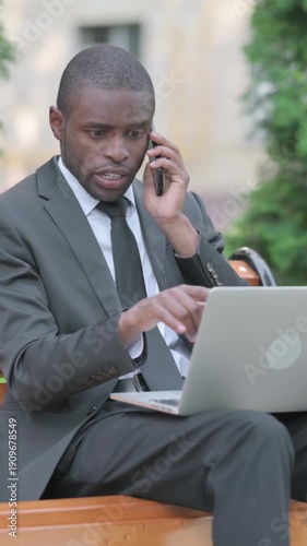 Wallpaper Mural African Businessman Talking on Phone at work, Vertical Video Torontodigital.ca