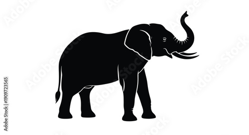 Black silhouette of an elephant standing with trunk raised