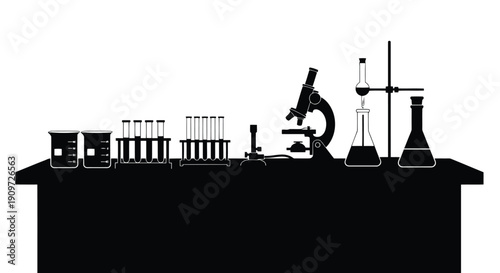 Laboratory equipment silhouette on a table with microscope, beakers, and test tubes