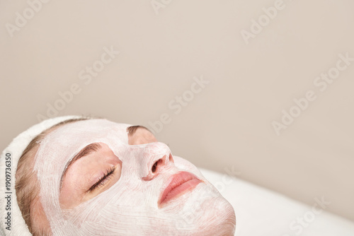 Картината върху платно Caucasian female adult relaxing with a facial mask for skincare and rejuvenation