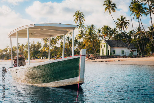 Obraz na plátně Carneiros, PE, Brazil - November 1st 2025: Fishing Boat in front of Saint Benedi