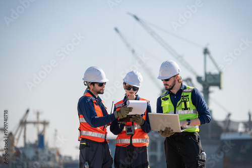 Professional engineering working at shipyard, Professional logistics monitoring cargo operations at industrial shipyard.