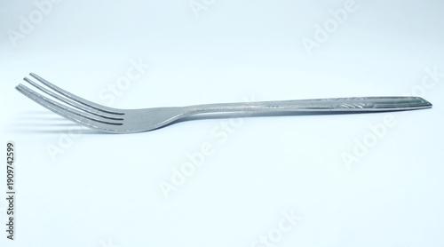 Shiny metal fork utensil isolated on background