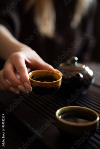 Chinese Tea Ceremony. Woman grabbing tea cup