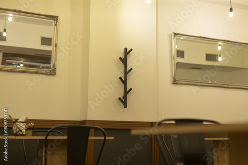 Relaxed rustic cafe. Casual cafe setting with wooden decor and reflective mirrors present. Leisurely rustic coffee environment featuring vintage furniture and mirror reflections enhancing charm