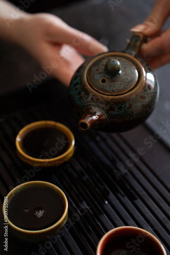 Chinese Tea Ceremony Close Up – Teapot and Small Cups on Tea Table
