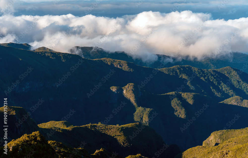 Fototapeta premium Aerial view of winding mountain road above the clouds.