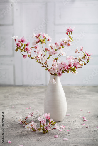 Vase with cherry blossoms on kitchen table