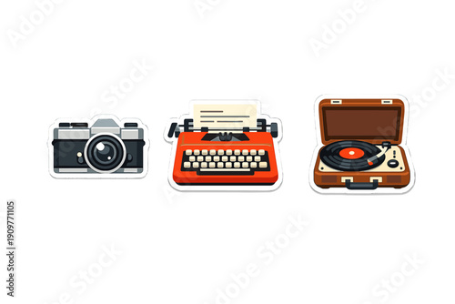 Three retro-themed stickers including a silver film camera, a bright red typewriter, and a brown record player with a vinyl disc, isolated on a plain black background.