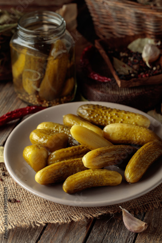 Canvas-taulu Homemade canned gherkins on a rustic wooden background.