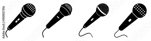 Set of four black microphones isolated on white background for music, speech, podcast, and broadcasting