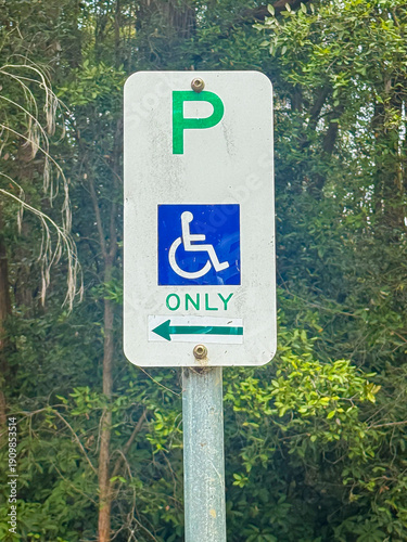 Photos Photograph of a functioning but old and deteriorating disabled parking sign located in a grassy area near a forest in the Blue Mountains in New South Wales, Australia