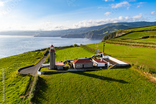 Slika na platnu Lighthouse on cape Cintrao with Cliffs and Green Fields and Atlantic Ocean