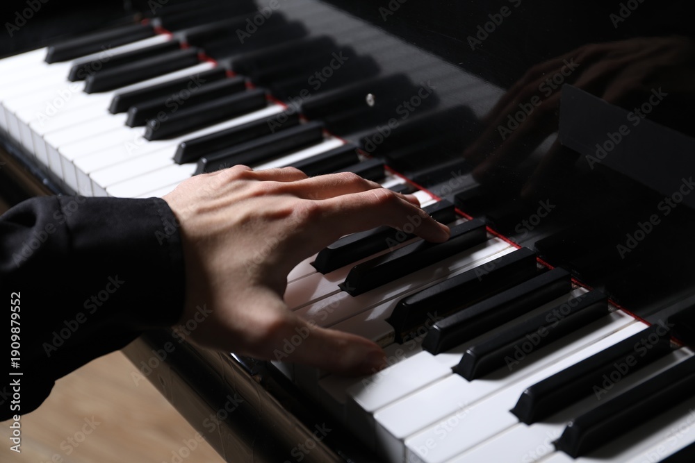 Obraz premium Musician playing piano indoors, closeup. Musical instrument