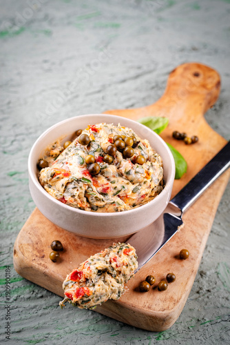 Artisan sun dried tomato butter - compound butter spread with fresh herbs, dry  tomatos, green pepper and wild garlic served as close-up in a bowl