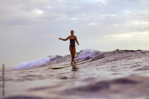 Woman Gliding On Wave At Golden Hour, Capturing Cinematic Sunset Vibe With Poised Stance And Warm Reflections