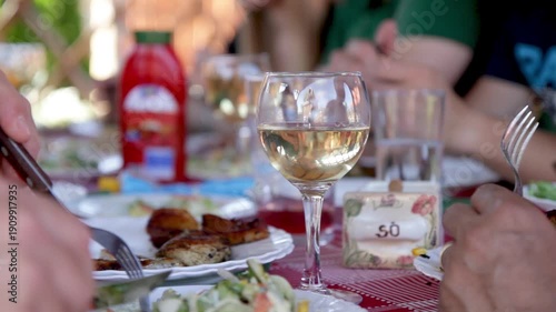 People Dining At Garden Party With Wine